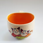 Lässige Keramik Tasse / Becher orange Katze mit Fisch